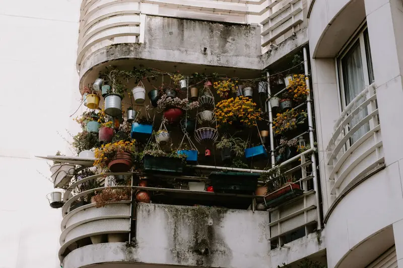 Low angle view of a balcony brimming with vibrant potted plants on a building exterior